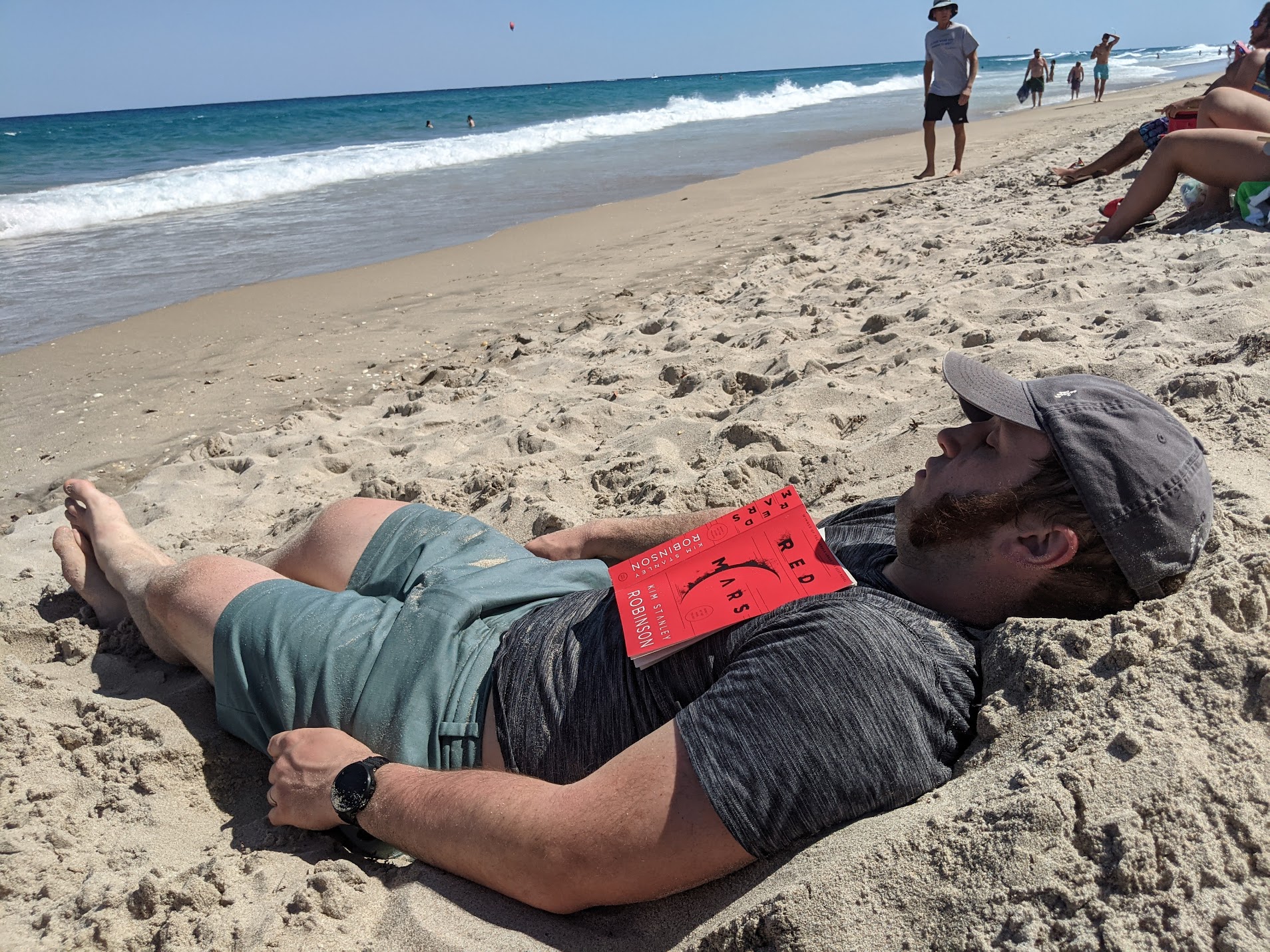 Me, dirty and unshaven, sleeping on a beach